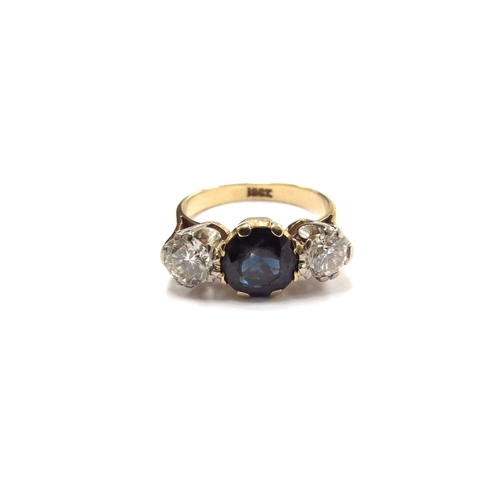 6007 - A sapphire and diamond three stone ring, the central round sapphire (worn to top) flanked by 0.25ct ... 