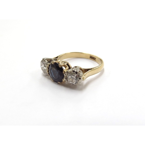 6007 - A sapphire and diamond three stone ring, the central round sapphire (worn to top) flanked by 0.25ct ... 