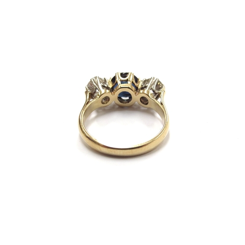 6007 - A sapphire and diamond three stone ring, the central round sapphire (worn to top) flanked by 0.25ct ... 