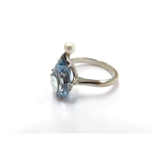 6005 - A white gold ring set with a pear cut aquamarine with single pearl to point, stamped 18ct. Size L, 4... 