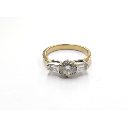 6012 - A gold platinum set diamond solitaire ring 0.70ct approx diamond, flanked by baguette cut diamond sh... 