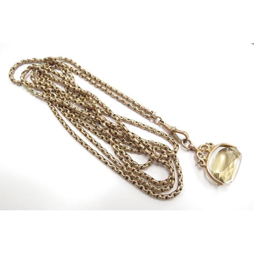 6032 - A gold guard chain stamped 9ct, 151cm long hung with a citrine swivel fob, 38.3g total