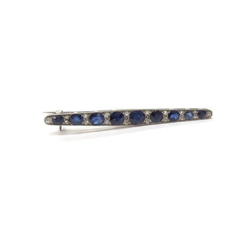 6008 - A diamond and sapphire bar brooch, nine graduated oval sapphires spaced by diamonds, unmarked, 5.5cm... 