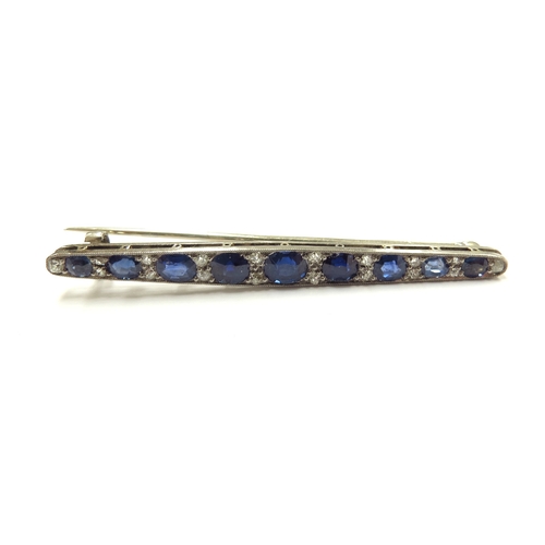 6008 - A diamond and sapphire bar brooch, nine graduated oval sapphires spaced by diamonds, unmarked, 5.5cm... 