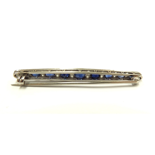 6008 - A diamond and sapphire bar brooch, nine graduated oval sapphires spaced by diamonds, unmarked, 5.5cm... 