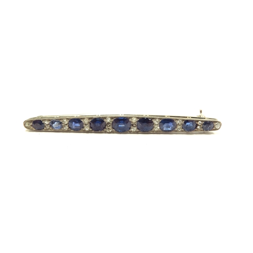 6008 - A diamond and sapphire bar brooch, nine graduated oval sapphires spaced by diamonds, unmarked, 5.5cm... 