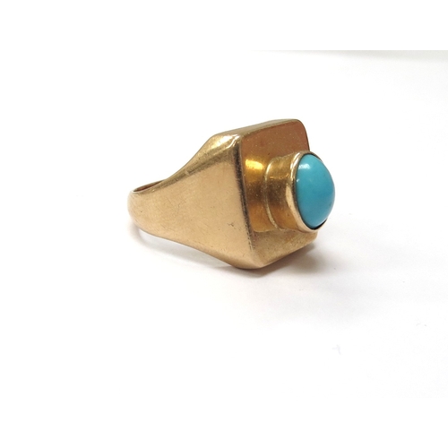 6026 - A gold ring circa 1970 set with a single turquoise cabochon, outside shank marked 750. Size O, 9.1g