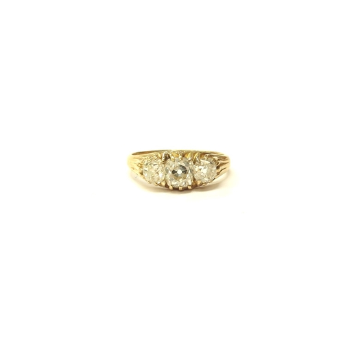 6027 - A three stone diamond ring in 18ct gold, 1.50ct total approx of old cut diamonds. Size N, 3.2g. With... 