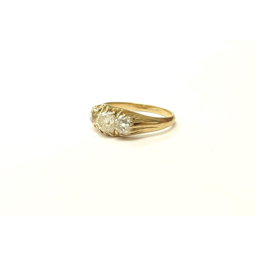 6027 - A three stone diamond ring in 18ct gold, 1.50ct total approx of old cut diamonds. Size N, 3.2g. With... 