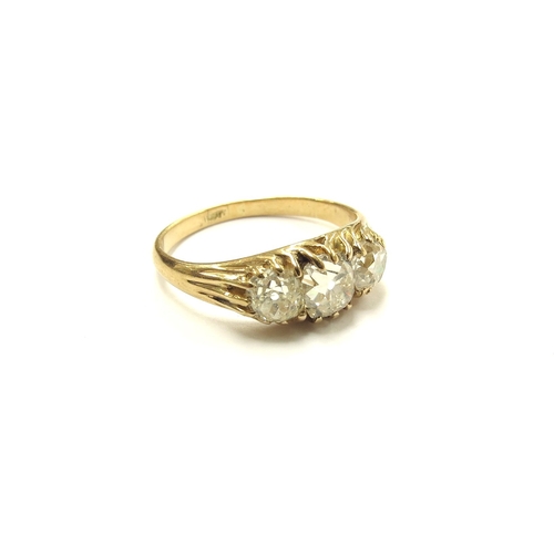 6027 - A three stone diamond ring in 18ct gold, 1.50ct total approx of old cut diamonds. Size N, 3.2g. With... 