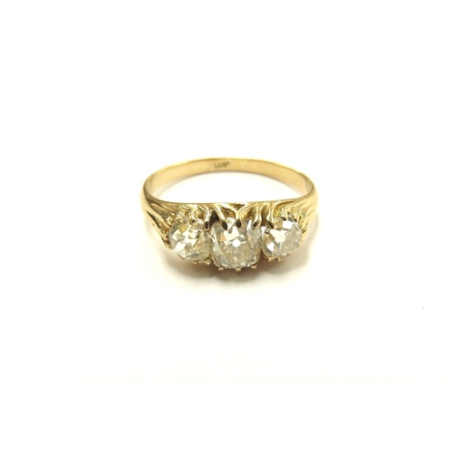 6027 - A three stone diamond ring in 18ct gold, 1.50ct total approx of old cut diamonds. Size N, 3.2g. With... 