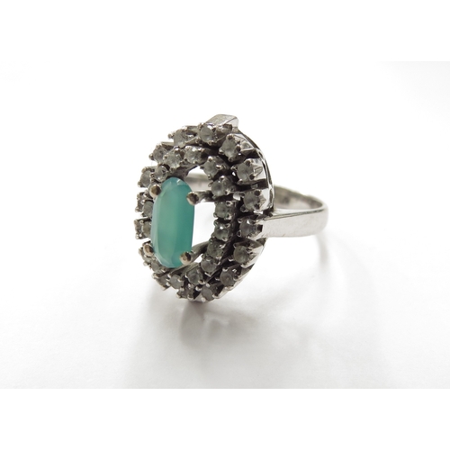 6161 - A white gold emerald and clear stone cluster ring. Size P, 6.4g