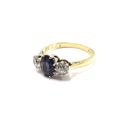 6299 - An 18ct gold three stone diamond and sapphire ring the central oval sapphire flanked by 0.20ct appro... 