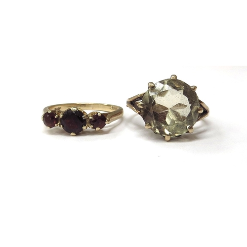 6075 - A 9ct gold citrine ring, size L and a gold three stone garnet ring stamped 9k, size M, 6.2g