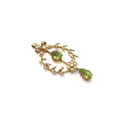 6128 - An Edwardian pearl and peridot drop pendant, stamped 15ct, 4.5cm long, 3.9g