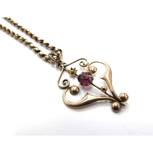 6046 - An Edwardian gold pendant centrally set with single garnet, stamped 9ct hung on a gold belcher chain... 