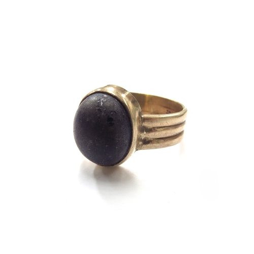 6331 - A gold ring stamped 9ct with an oval cabochon Lapis Lazuli, worn. Size T/U, 8g