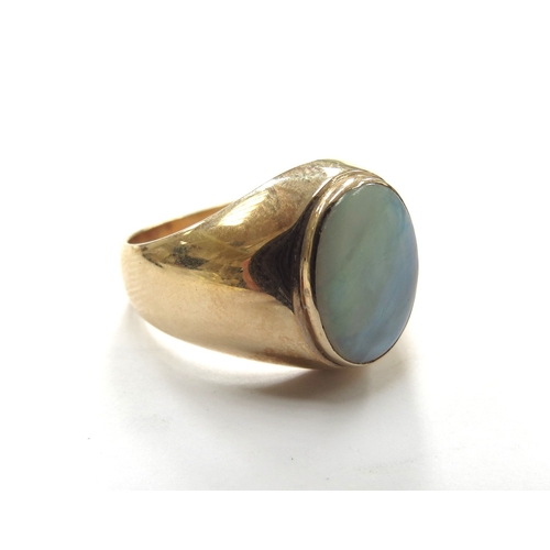 6047 - A gold signet ring with an oval opal in rub over setting, stamped 14k. Size U, 6g