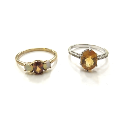 6110 - Two 9ct gold rings, both centrally set with citrine one flanked by opals and the other with diamond ... 