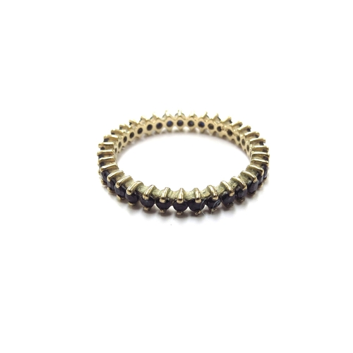 6318 - A 9ct gold sapphire eternity ring. Size T, 2.3g