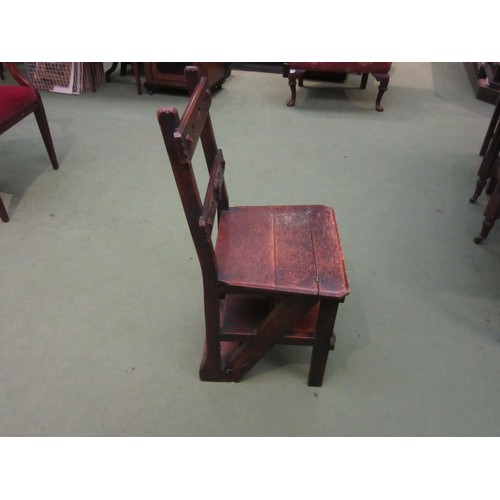 1021 - An oak Gothic-style metamorphic library chair/steps, monogram to back rail. 84cm tall.