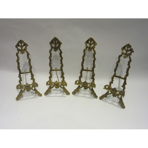 1013 - Four 20th Century brass table-top easels, 30cms tall.