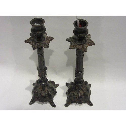 1009 - A pair of cast iron candlesticks 26cm tall