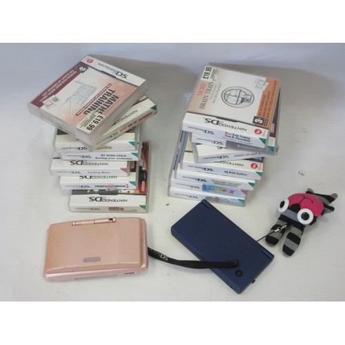 1073 - Two Nintendo DS handheld computer game consoles and a collection of games.