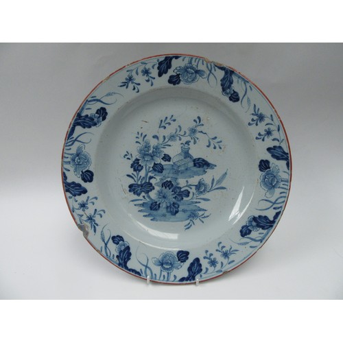 6273 - A late 18th/early 19th Century tin glazed delft charger with floral border and central tree and vase... 