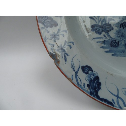 6273 - A late 18th/early 19th Century tin glazed delft charger with floral border and central tree and vase... 