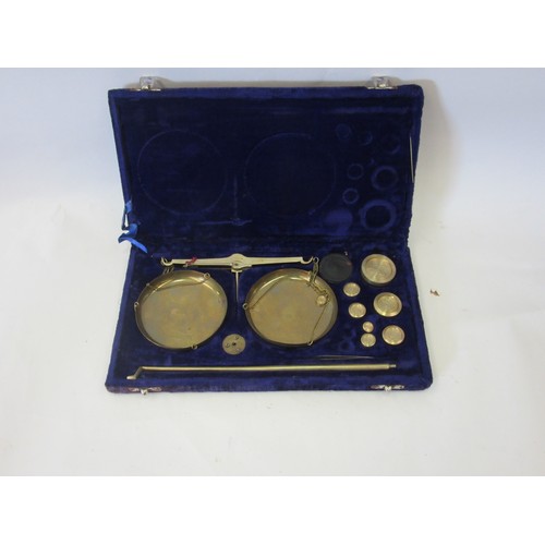 1042 - A set of late 20th Century Indian brass balance scales and weights. Cased.