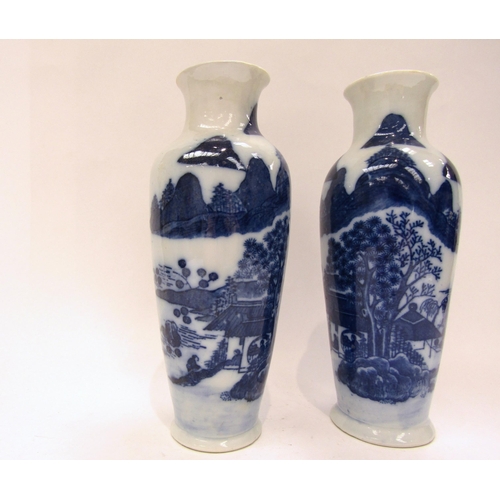 1187 - A near pair of Japanese blue and white ceramic vases with dwellings and rocky outcrop decoration, wi... 