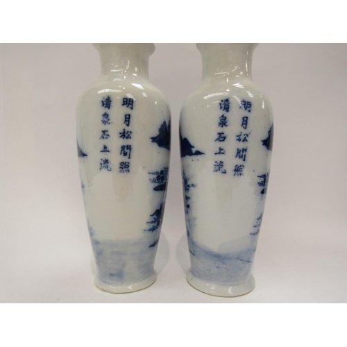 1187 - A near pair of Japanese blue and white ceramic vases with dwellings and rocky outcrop decoration, wi... 