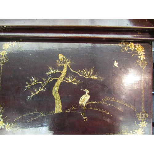 1194 - A Chinese lacquered nest of four tables with gilt scenes of birds among foliage, largest 69cm tall x... 