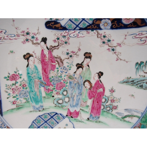 1204 - A Japanese porcelain charger with enamel decoration, the floral and gold border surrounds an image o... 