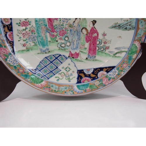 1204 - A Japanese porcelain charger with enamel decoration, the floral and gold border surrounds an image o... 