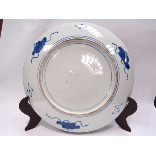 1204 - A Japanese porcelain charger with enamel decoration, the floral and gold border surrounds an image o... 