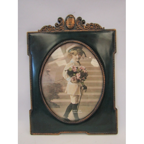 1445 - A green and gilded resin oval easel back picture frame, 36.5cm x 27cm overall dimensions