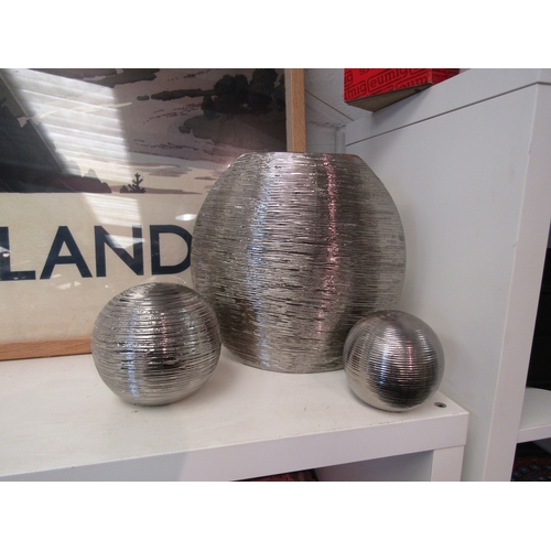 1448 - A ribbed silvered ovoid vase, 26cm tall, and two matching spheres (3)