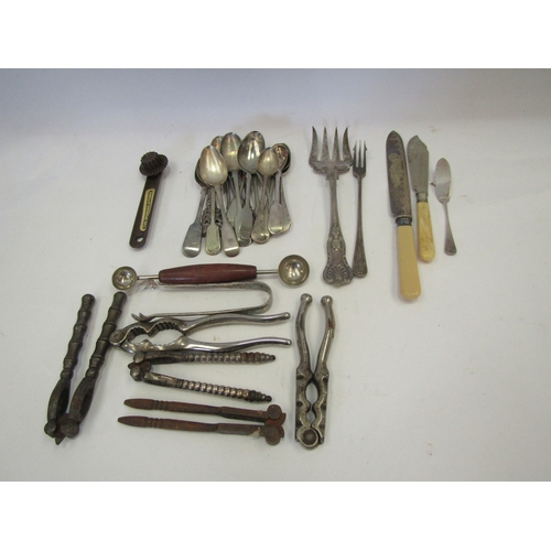 1499 - A quantity of plated flatware to include bread fork, teaspoons, knives, melon scoop, nutcrackers, et... 