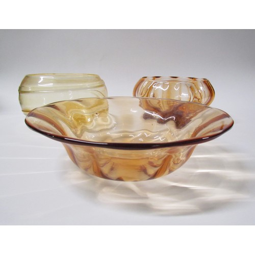 1542 - A Whitefriars waved bowl in Amber, 26.5cm diameter, a trailed bowl, 18cm and a pedestal bowl in dark... 