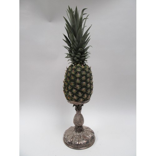 6379 - A Victorian silver pineapple stand. The embossed pineapple holder above a pineapple form stem over a... 