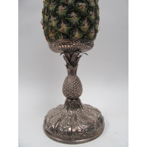 6379 - A Victorian silver pineapple stand. The embossed pineapple holder above a pineapple form stem over a... 