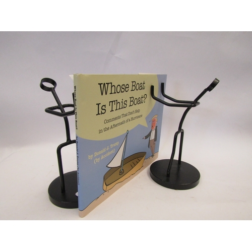 1105 - A pair of cast metal figural book-ends together with a book titled 