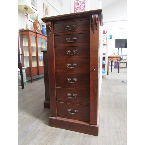 1106 - A late 19th Century oak Wellington chest of seven drawers with Art Nouveau handles, with key, 103cm ... 