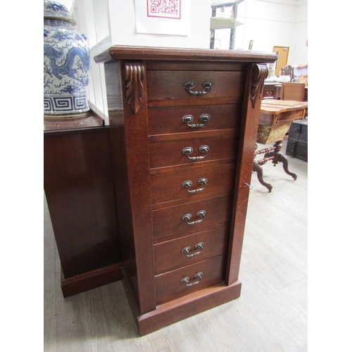 1106 - A late 19th Century oak Wellington chest of seven drawers with Art Nouveau handles, with key, 103cm ... 