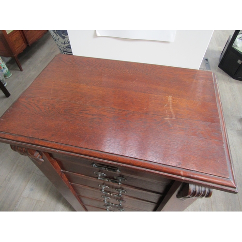 1106 - A late 19th Century oak Wellington chest of seven drawers with Art Nouveau handles, with key, 103cm ... 