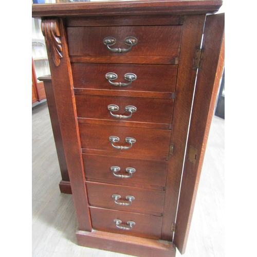 1106 - A late 19th Century oak Wellington chest of seven drawers with Art Nouveau handles, with key, 103cm ... 