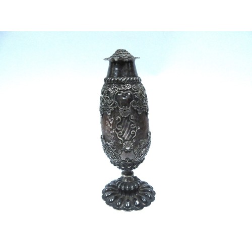 6327 - A 19th Century continental heavily carved nut bottle, encased in an ornate white metal frame. 18cm t... 