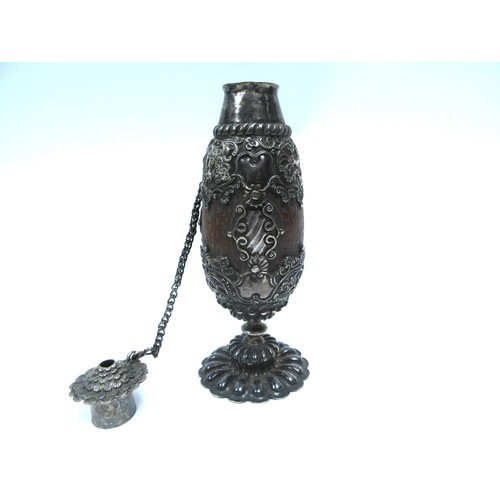 6327 - A 19th Century continental heavily carved nut bottle, encased in an ornate white metal frame. 18cm t... 